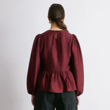 Crinkle satin blouse in burgundy with long sleeves and peplum shape  