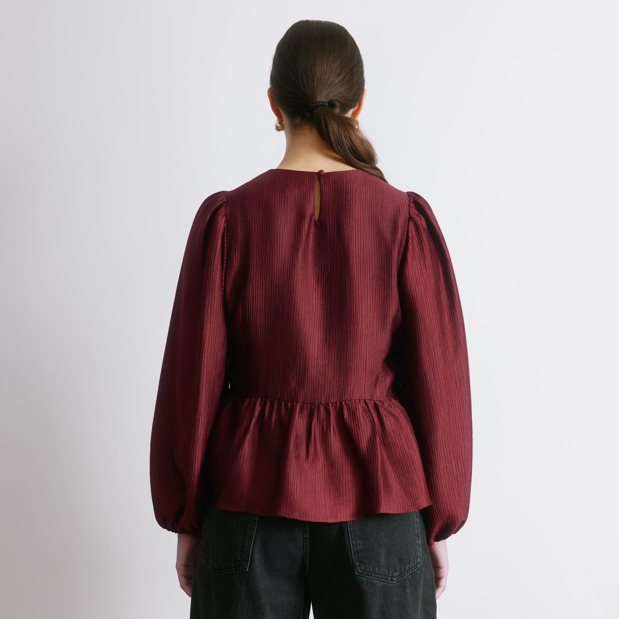 Crinkle satin blouse in burgundy with long sleeves and peplum shape  