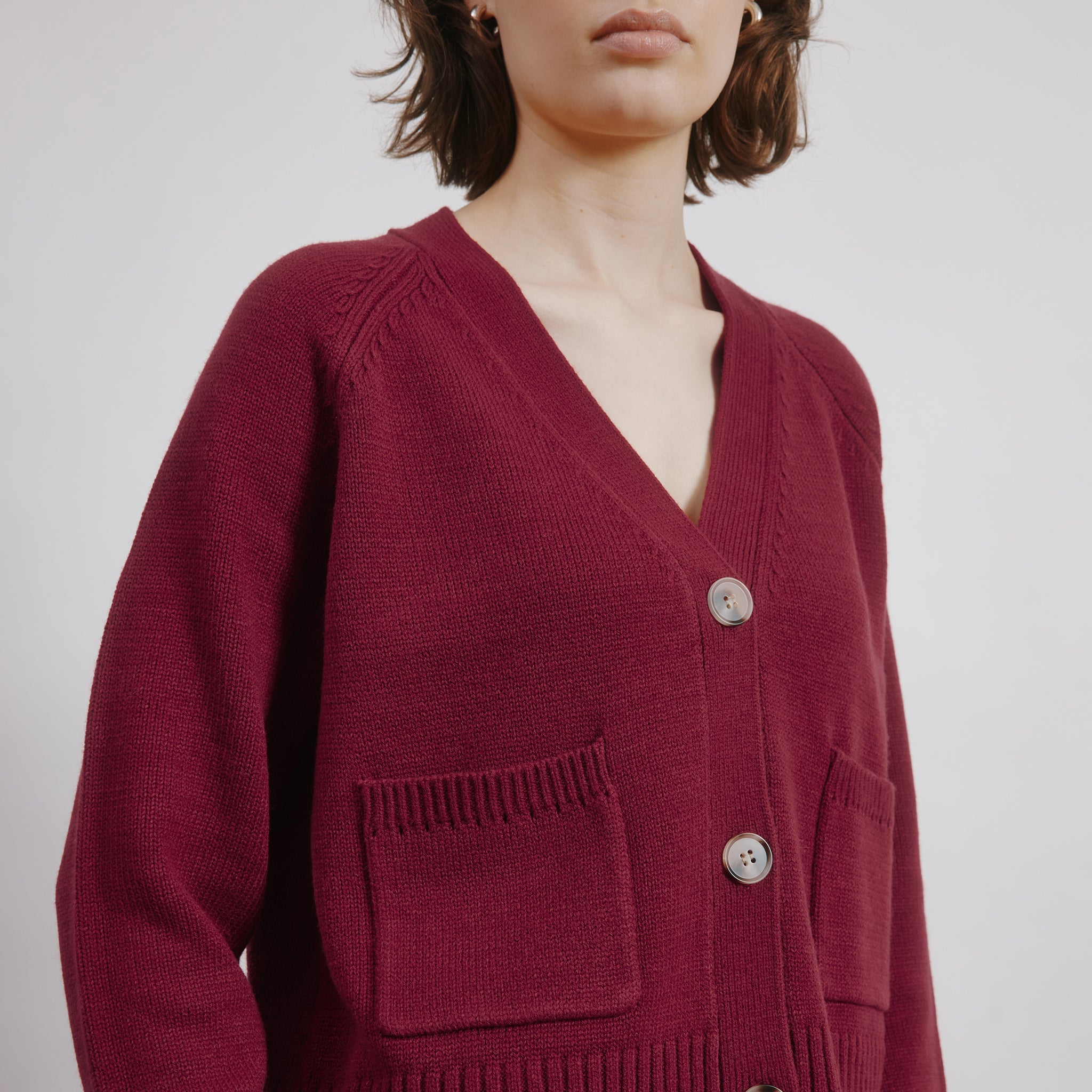 Burgundy v neck cardigan crafted in dark red knit for layering wear  