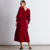Red velvet dress with a luxurious crushed texture and elegant slash neckline for evening occasions.  