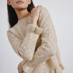 Feminine wool jumper featuring ruffle neckline and delicate knit texture  