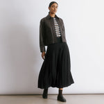 Recycled polyester black skirt featuring classic pleats and a versatile midi length for everyday elegance.  