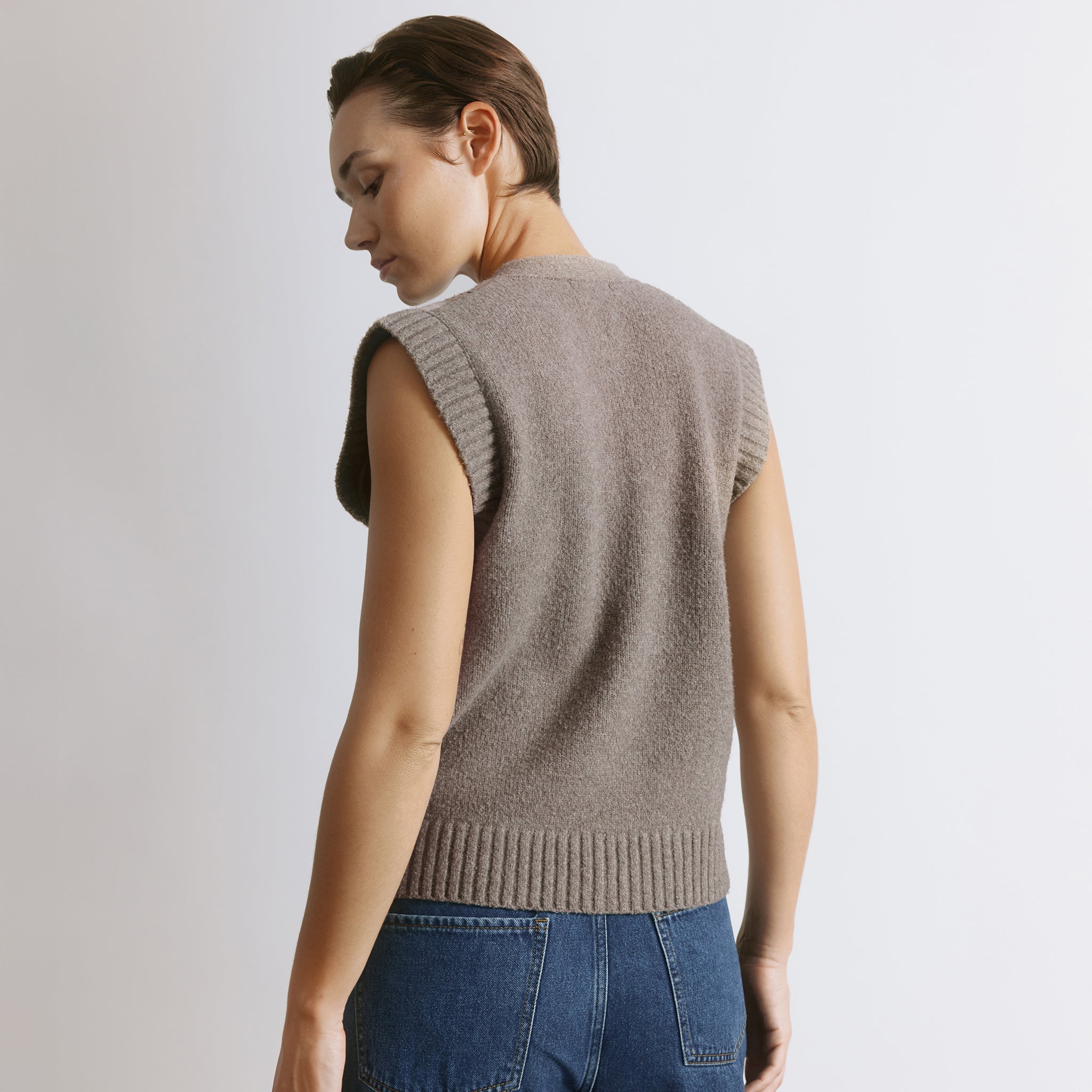 Argyle sweater vest in classic knit design with button front detailing  