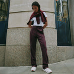 Retro stripe burgundy track pants with straight leg cut, comfortable jersey fabric, drawstring waist, eco-conscious and ethically made loungewear essential.