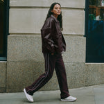 Casual burgundy track pants with retro stripes on straight leg joggers, organic cotton material, perfect for sustainable and ethically produced loungewear.