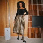 Full silhouette animal print midi skirt offering a striking look for elevated day-to-night styling.