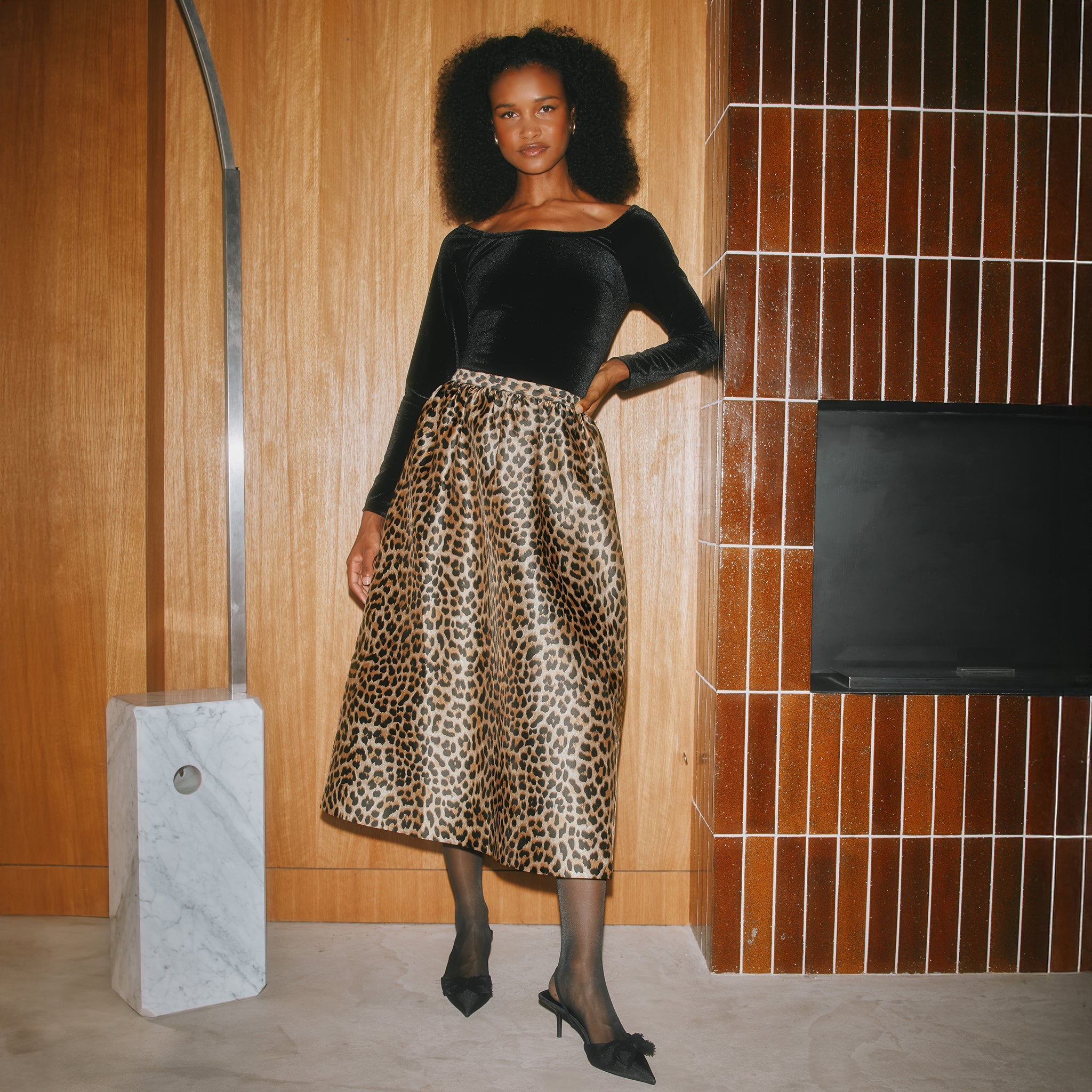 Full silhouette animal print midi skirt offering a striking look for elevated day-to-night styling.