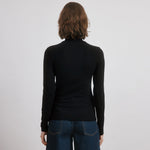 Long sleeve layering top in black slim fit jersey, classic roll neck style, perfect minimalist winter staple with organic cotton jersey fabric, sustainable and ethically made turtleneck. 