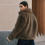 Chocolate faux fur jacket with a cropped silhouette, crafted from plush soft brown faux fur for a cosy winter look.  