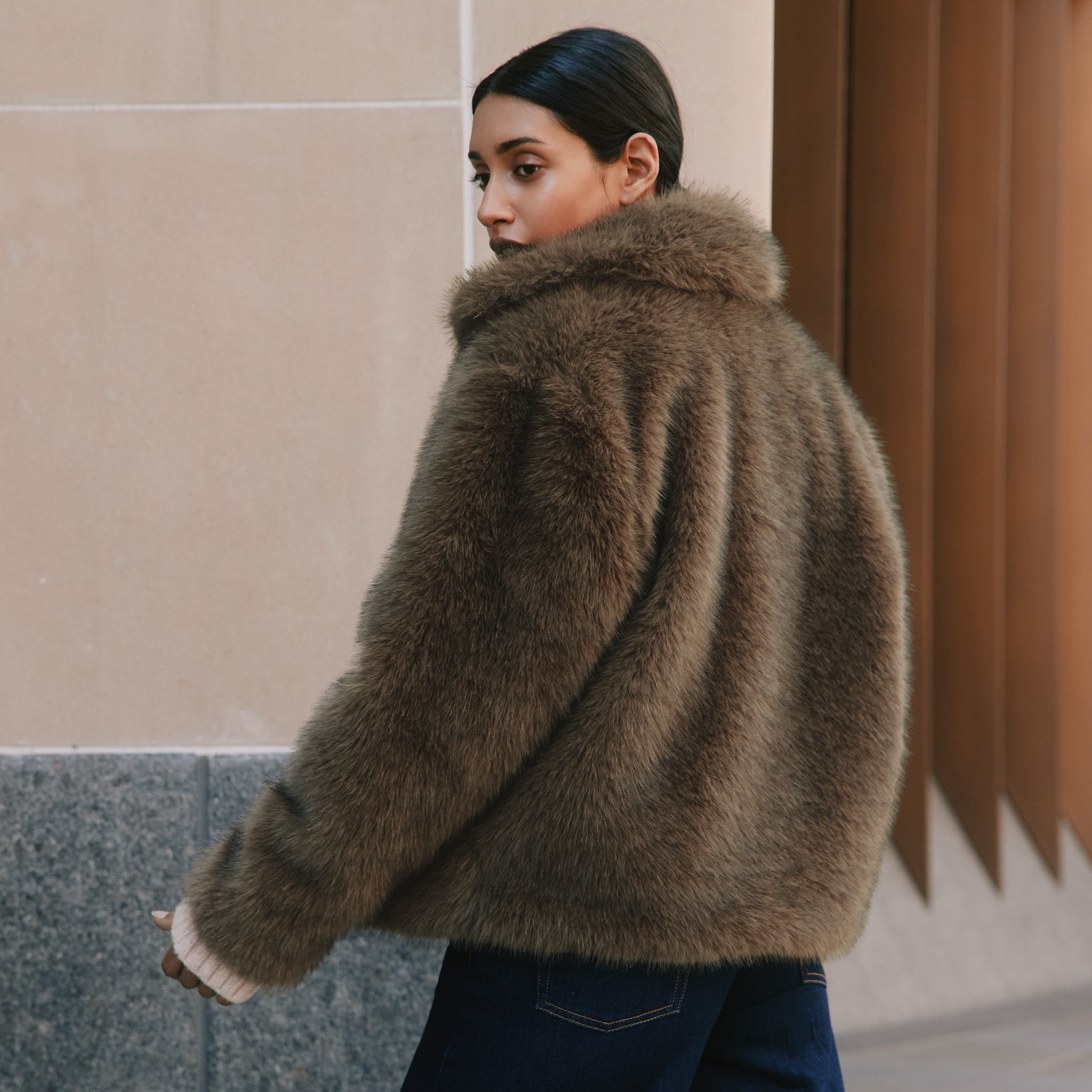 Chocolate faux fur jacket with a cropped silhouette, crafted from plush soft brown faux fur for a cosy winter look.  