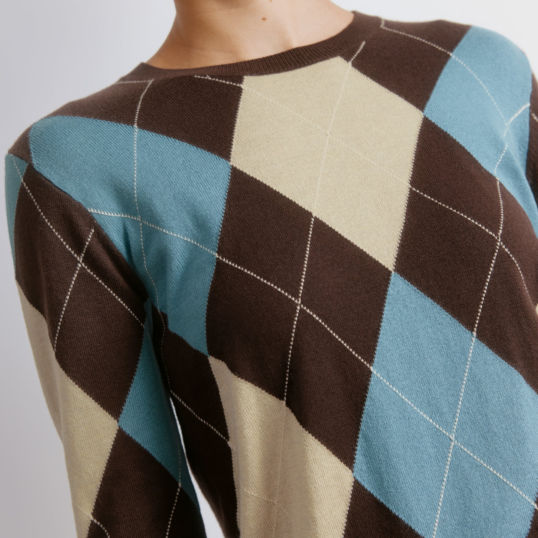 Argyle knit jumper featuring blue check pattern and timeless style  