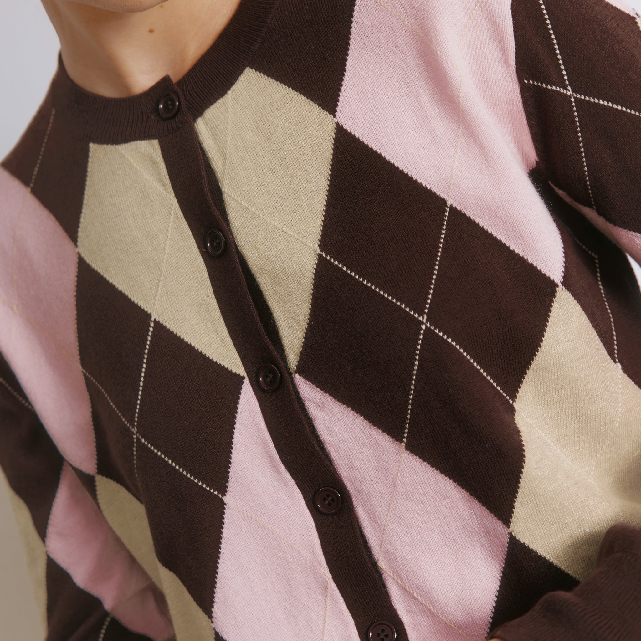 Patterned knit cardigan styled as a preppy womenÕs argyle sweater layer  