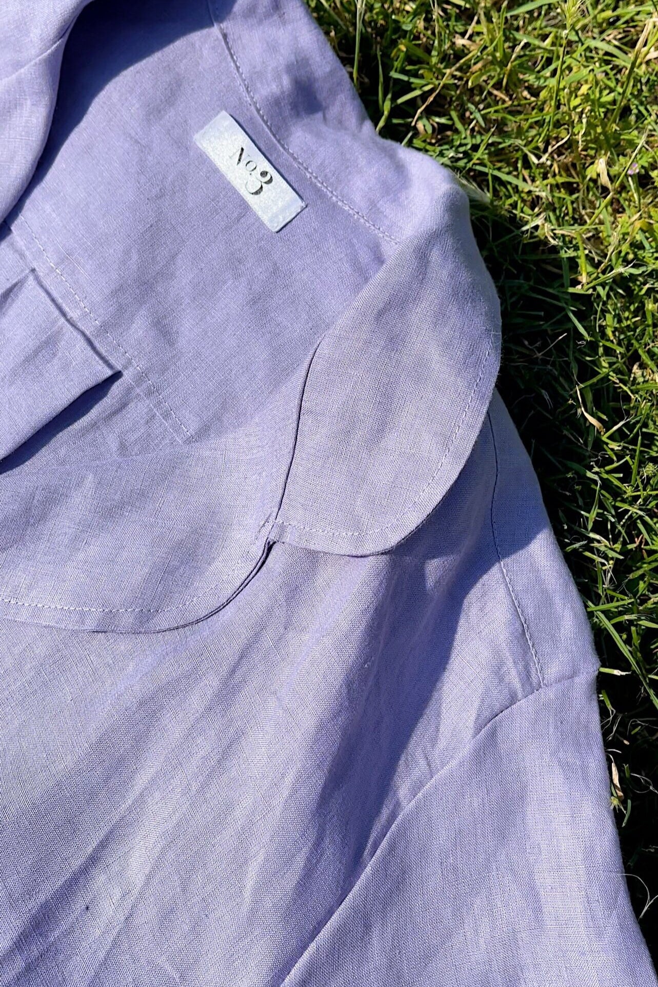 Short sleeve button up linen shirt with frill sleeves paired with high waisted linen shorts.