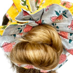 Soft green scrunchie featuring a bold floral print in an oversized design.