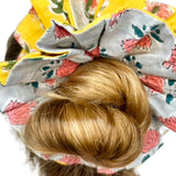 Soft green scrunchie featuring a bold floral print in an oversized design.