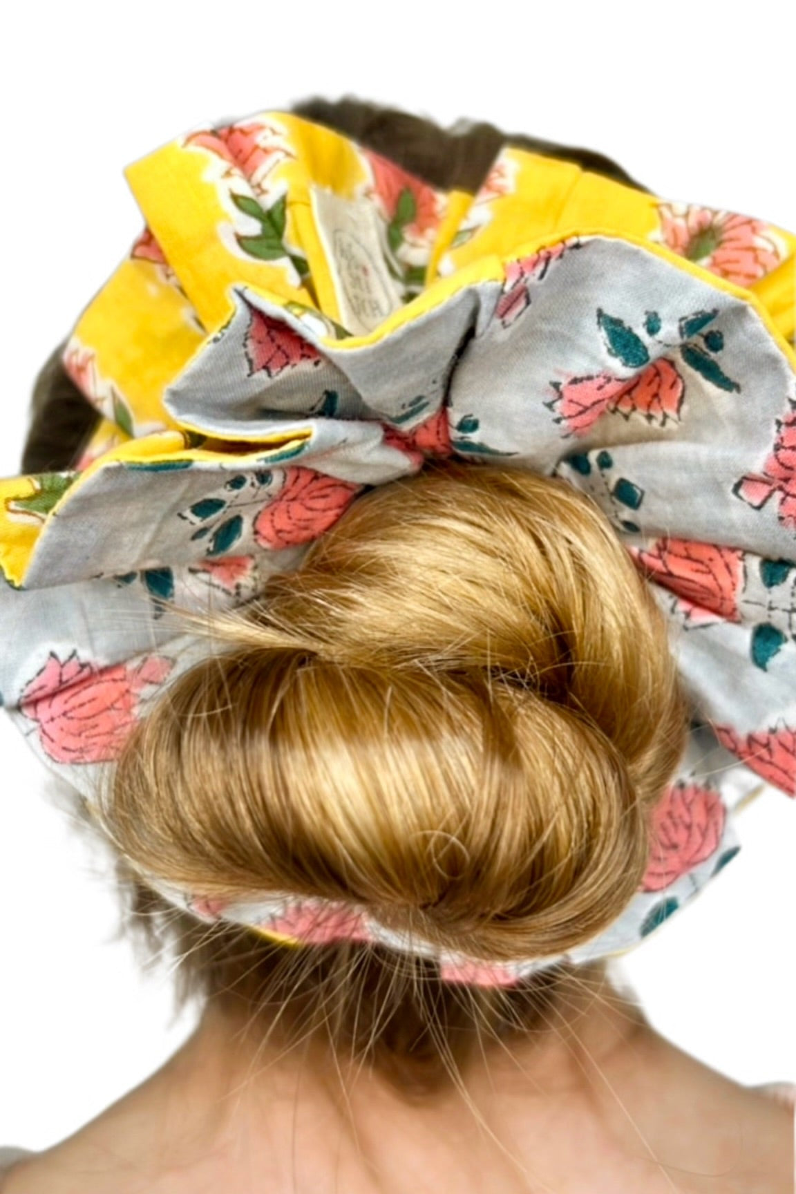 Soft green scrunchie featuring a bold floral print in an oversized design.