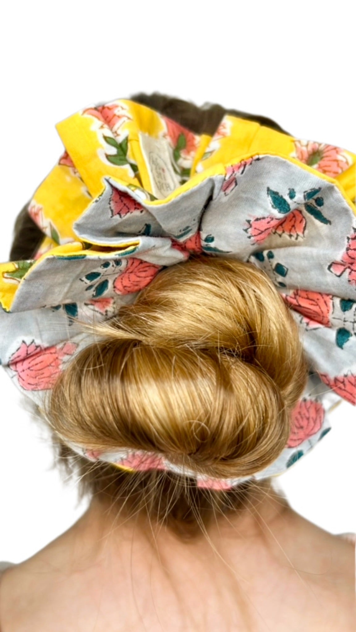 Soft green scrunchie featuring a bold floral print in an oversized design.