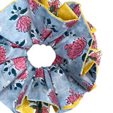 Large green scrunchie with floral design and textured fabric for a unique style.