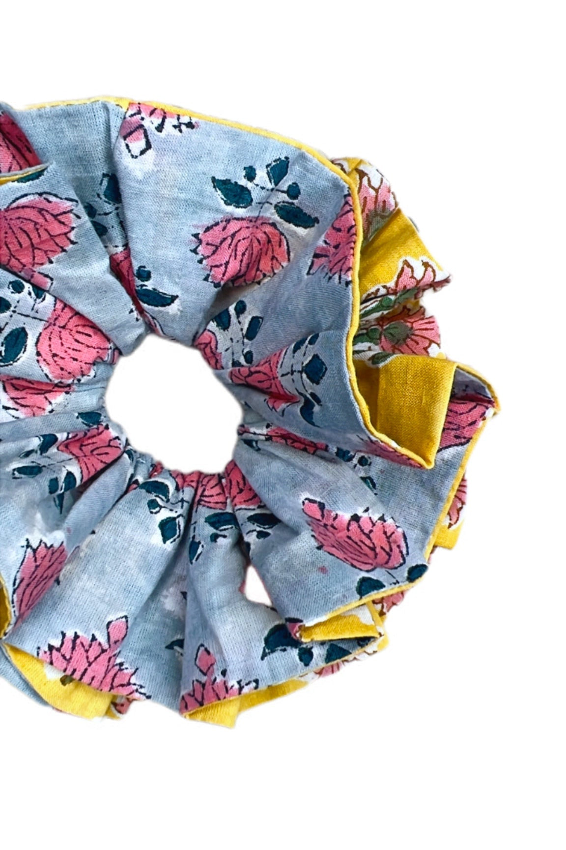 Oversized green floral scrunchie with voluminous fabric folds for a statement hair accessory.
