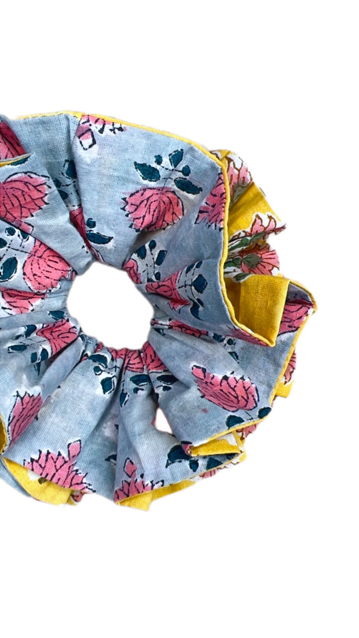 Oversized green floral scrunchie with voluminous fabric folds for a statement hair accessory.
