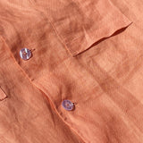 Short sleeve button up linen shirt with frill sleeves paired with high waisted linen shorts.