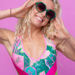 Close-up of green sunglasses highlighting the vibrant colourful frame.