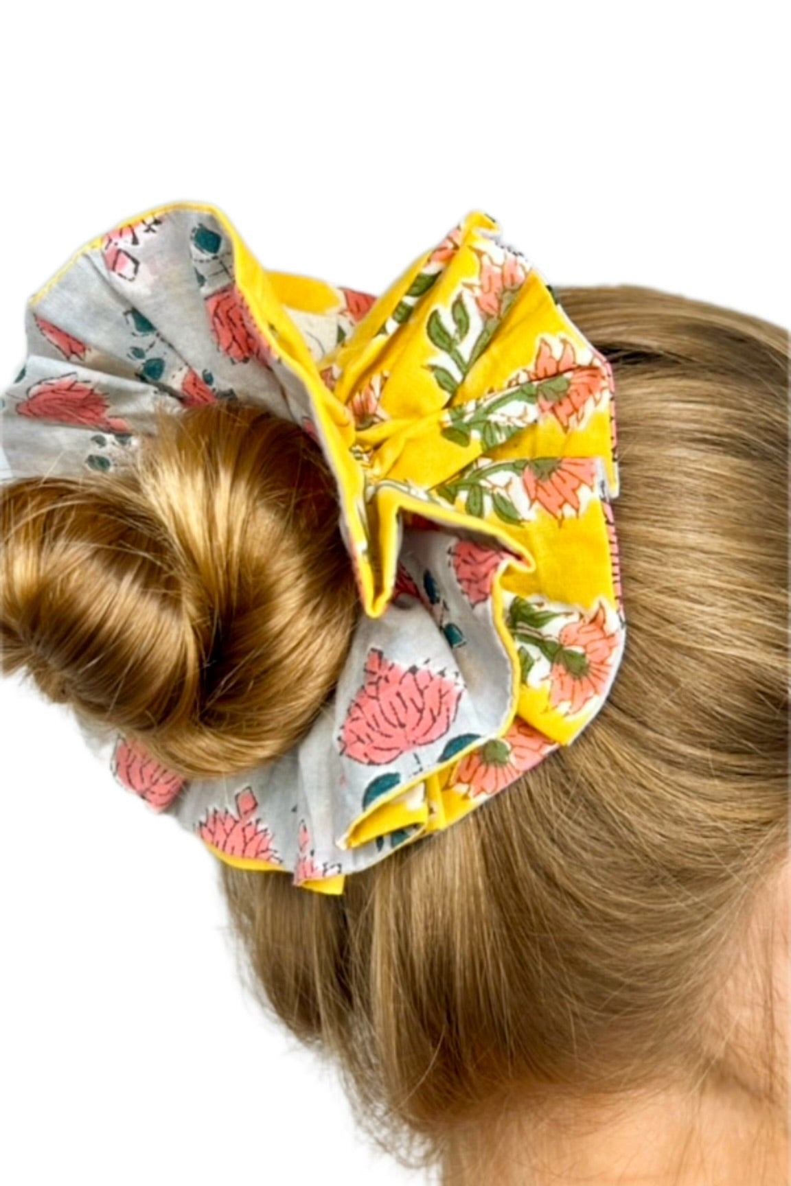 Close-up of floral pattern on a green oversized scrunchie highlighting fabric texture.