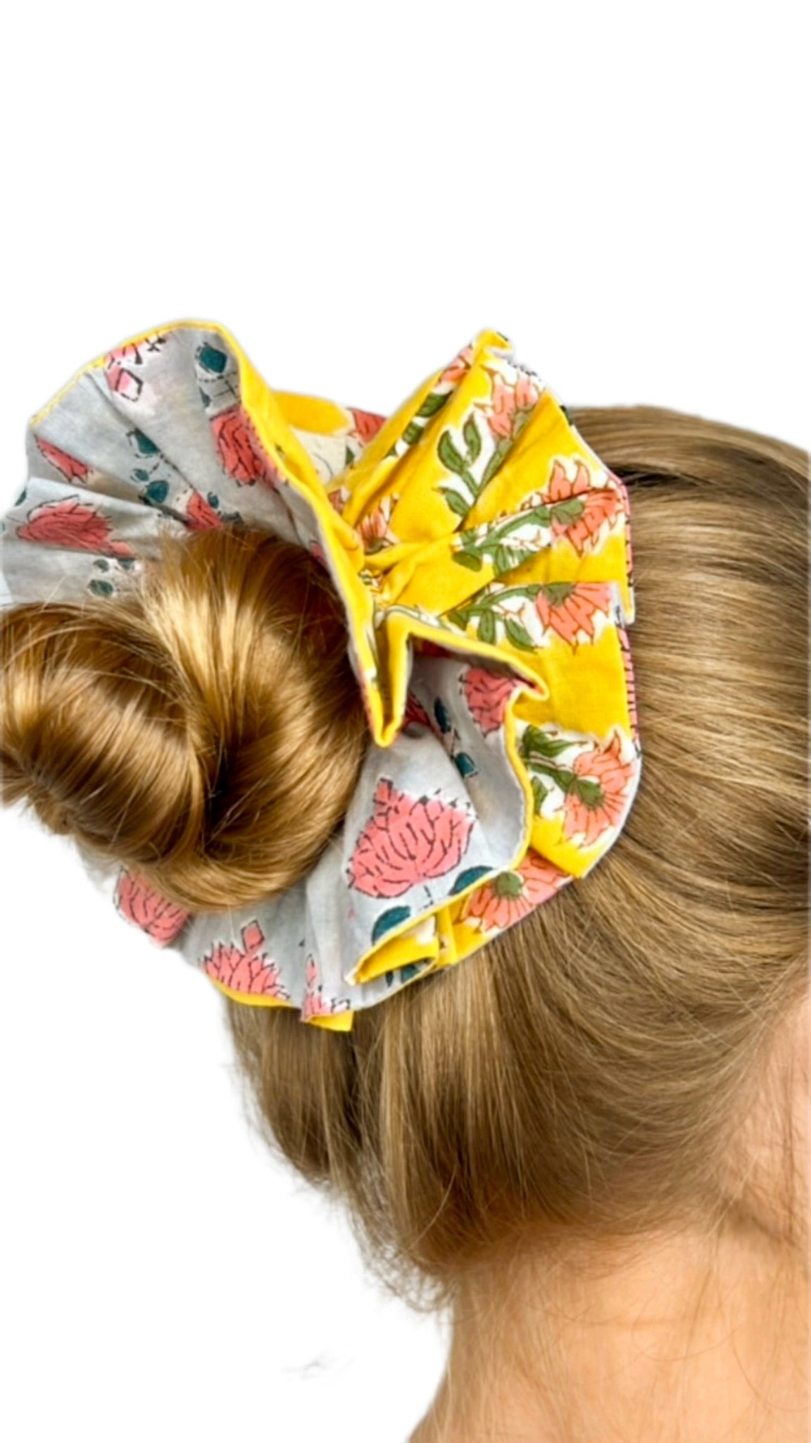 Close-up of floral pattern on a green oversized scrunchie highlighting fabric texture.