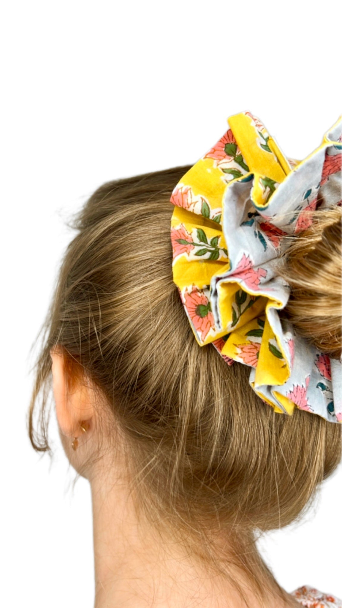 Green oversized scrunchie with floral pattern, perfect for adding color to hairstyles.