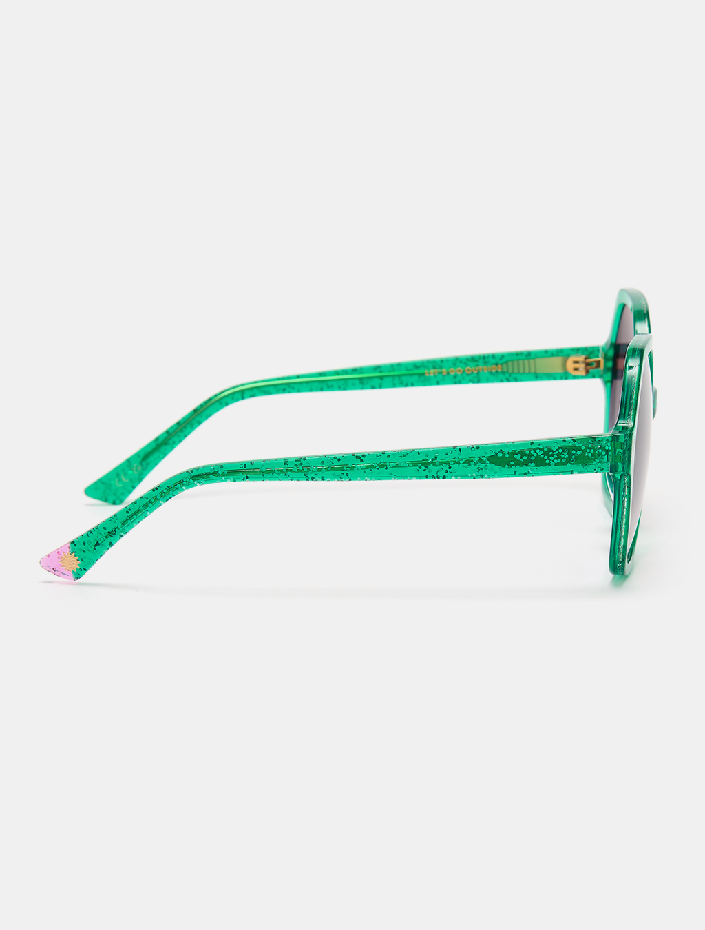 Woman wearing green colourful sunglasses with a bold fashion statement.