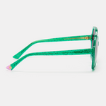 Woman wearing green colourful sunglasses with a bold fashion statement.