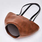 Brown leather handbag featuring gold hardware, made from high-quality upcycled leather