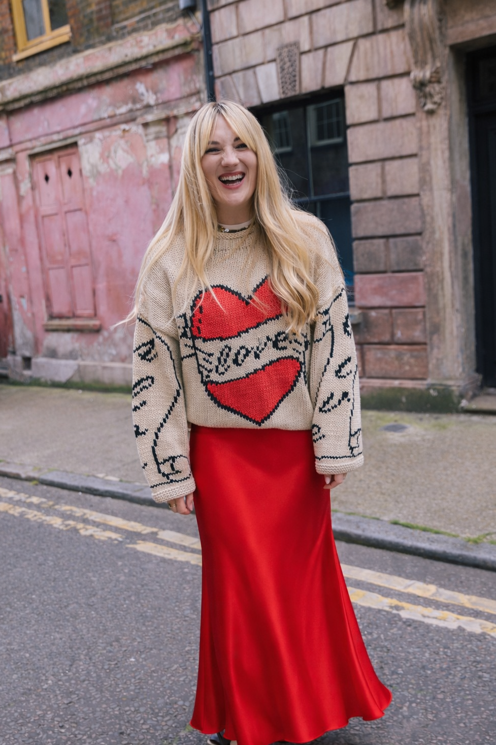 Slow Love Young Heart Jumper, flattering Red Satin Aldgate Skirt by Percy Langley. worn by fashion journalist and author Lauren Bravo