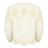 Elegant white blouse with long balloon sleeves, oversized collar, and embroidery along the cuffs.