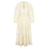 Woman wearing a summer maxi dress with an oversized collar and cinched waistline, styled in soft natural light.