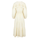 Side view of a lightweight cotton summer dress showing balloon sleeves and embroidered detailing on the bodice.
