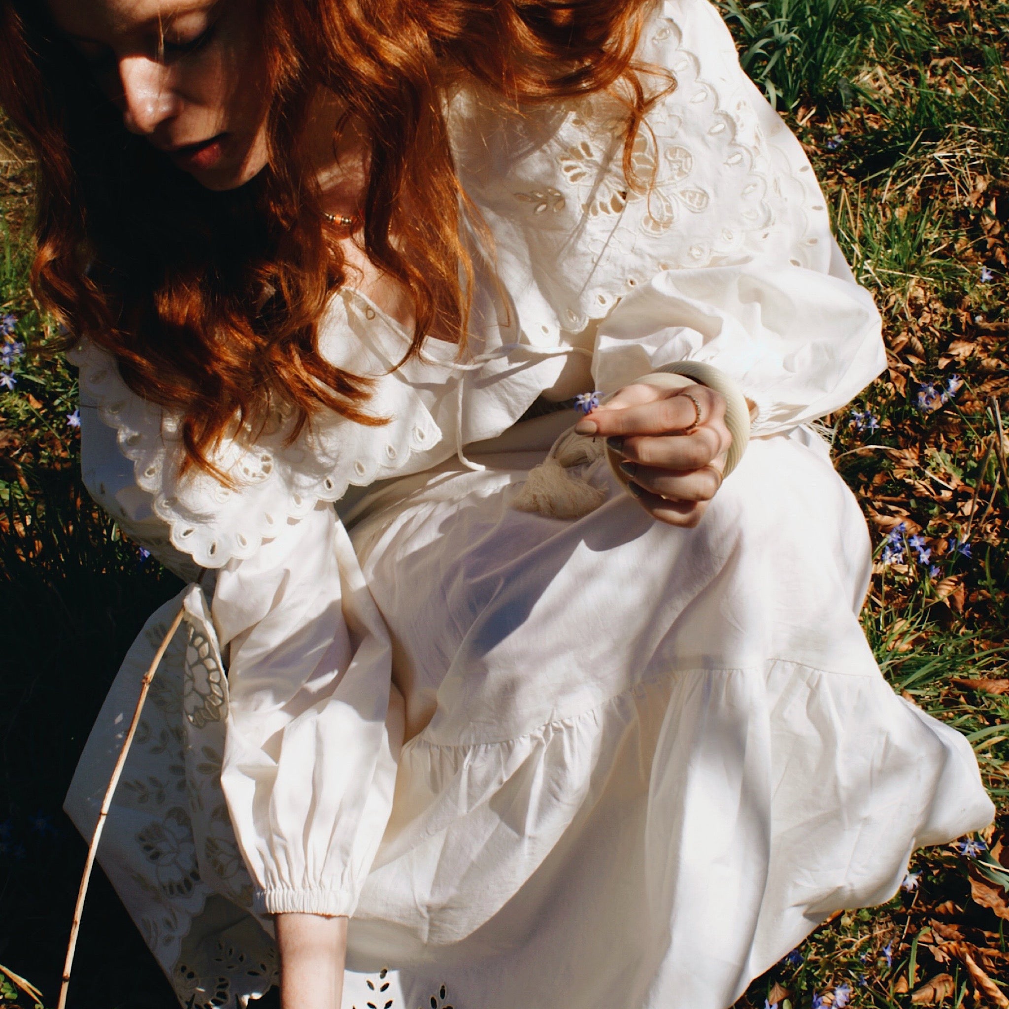 Outdoor shot of a model in a flowing summer maxi dress with cinched waistline and balloon sleeves.