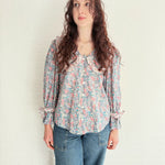 Model wearing Luna Floral Print Blouse made from deadstock fabric in pink and blue tones