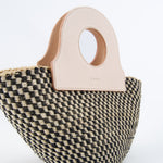 Close-up of natural basket bag with detailed weave, upcycled leather handbag