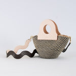 Basket bag featuring a natural color palette and black squiggle pattern, upcycled leather bag