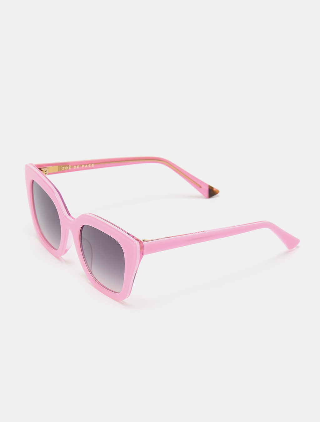 Three-quarter view of pink sunglasses emphasizing the vibrant frame color.