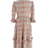 The Felicity Midi Dress in Rainbow Meadow print, made from sustainable cotton with a fitted bodice, full skirt, and stylish ruffled cuffs.