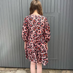 women wearing pink leopard dress back view