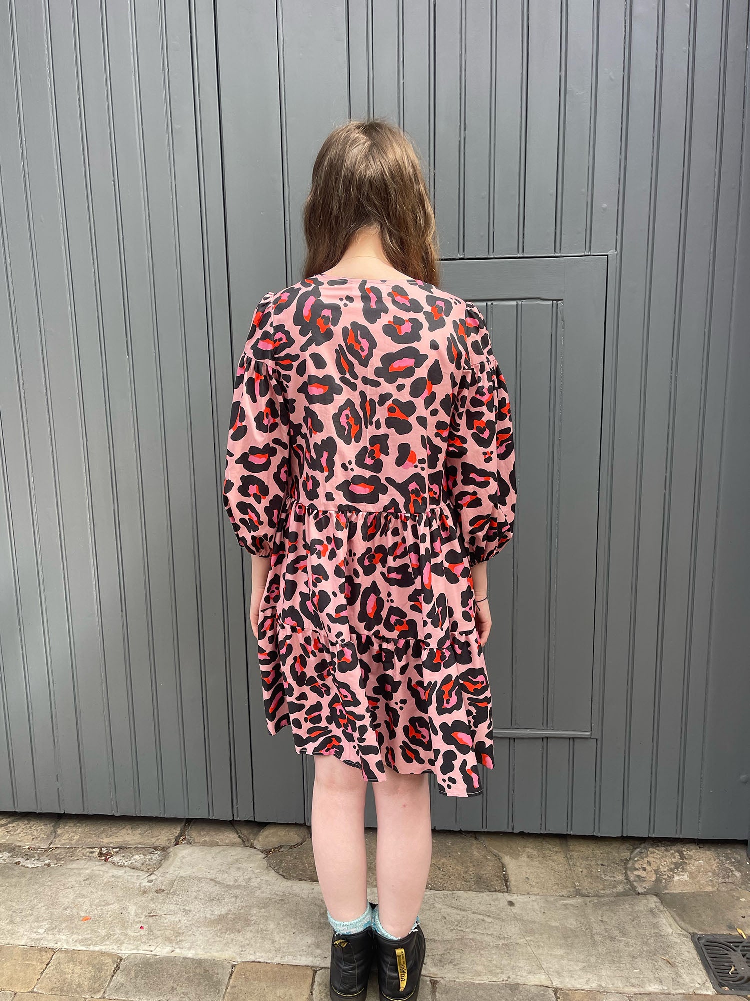 women wearing pink leopard dress back view