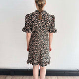 Back view of The Peony Dress showing soft structure and swingy silhouette.