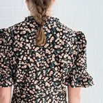 Close-up of bold floral print on ethically made cotton mini dress.
