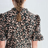 Close-up of bold floral print on ethically made cotton mini dress.