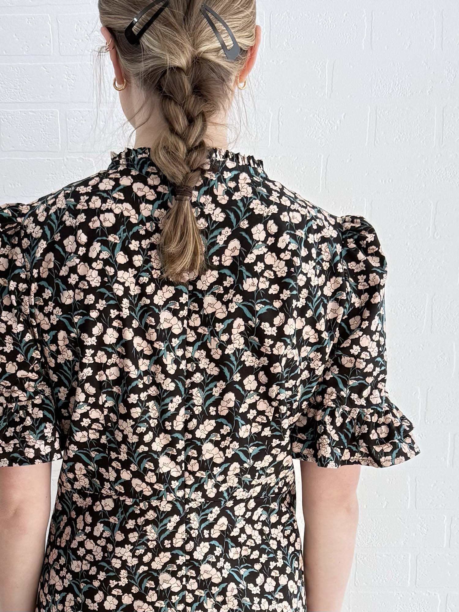 Close-up of bold floral print on ethically made cotton mini dress.