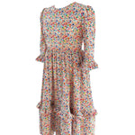 Side view of The Felicity Dress in Rainbow Meadow print, featuring a full skirt, side seam pockets, and gathered 3/4 sleeves with double ruffles.