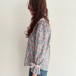 Sustainable vintage-inspired floral blouse with oversized collar and bow-detail cuffs
